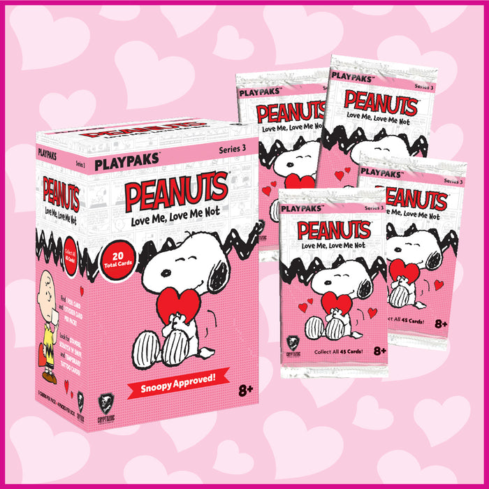 Peanuts-themed trading card packs and box on a pink background with heart designs